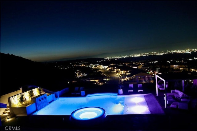 pool at twilight with a fenced in pool