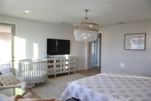 bedroom featuring a chandelier, visible vents, wood finished floors, and recessed lighting