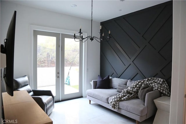 living room featuring an inviting chandelier, a healthy amount of sunlight, and french doors