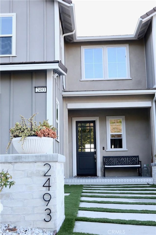 2493 Sierra Bella Dr, Corona, CA 92882 - view of exterior entry featuring stucco siding and a porch