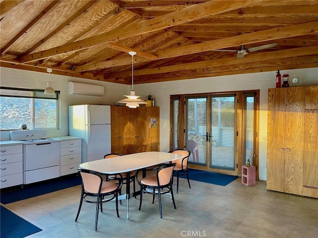 dining room featuring a wall mounted air conditioner, finished concrete floors, and lofted ceiling