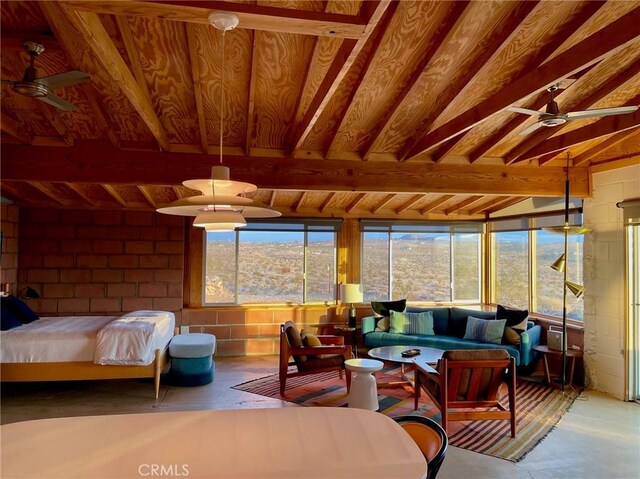 sunroom / solarium featuring beam ceiling and plenty of natural light