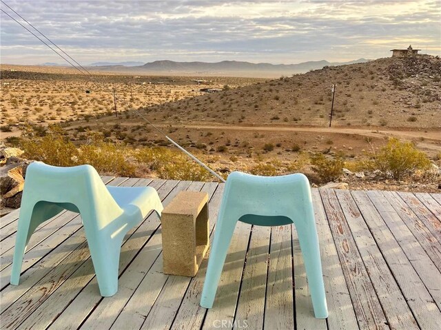 deck with a mountain view and view of desert