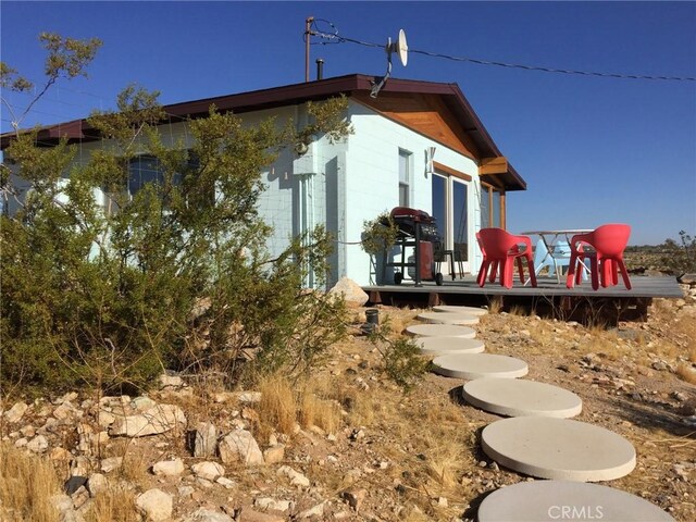 63465 Belmont St, Joshua Tree, CA 92252 - view of home's exterior with a deck and concrete block siding