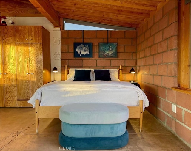 bedroom featuring unfinished concrete flooring, wood ceiling, and vaulted ceiling