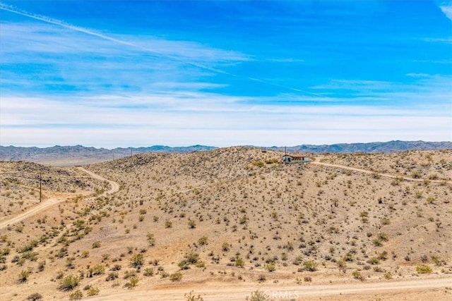 mountain view featuring view of desert and a rural view