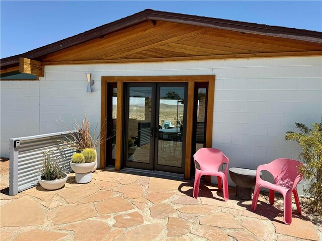 63465 Belmont St, Joshua Tree, CA 92252 - property entrance featuring a patio area, french doors, and concrete block siding