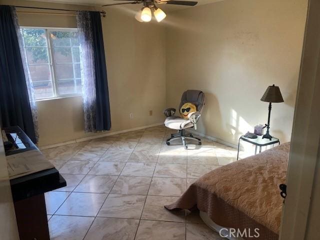 bedroom with baseboards and a ceiling fan