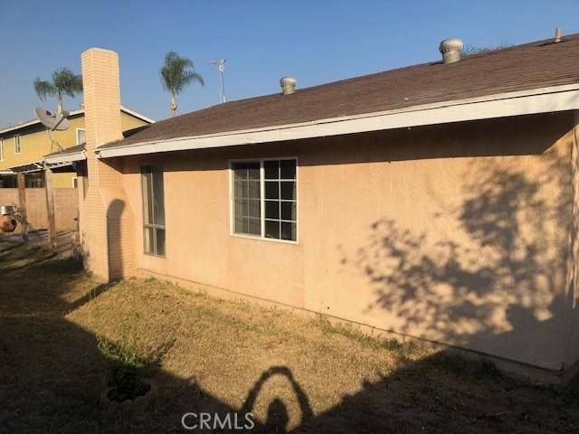 view of property exterior featuring stucco siding and a lawn