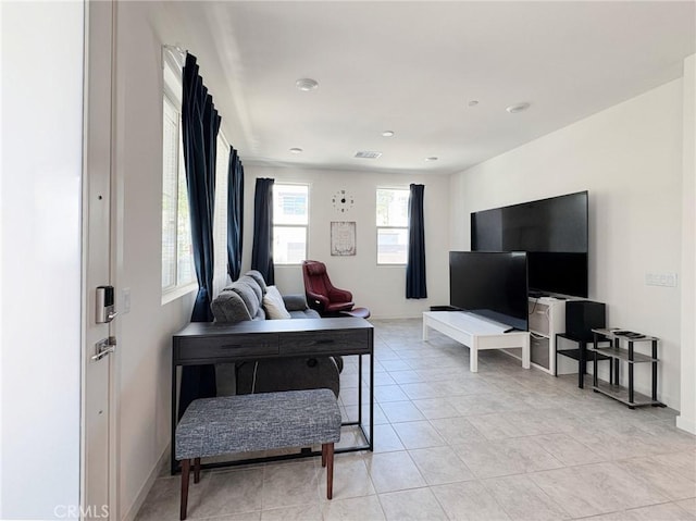 living area featuring visible vents and light tile patterned floors