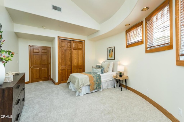 bedroom featuring lofted ceiling, light carpet, a closet, baseboards, and recessed lighting