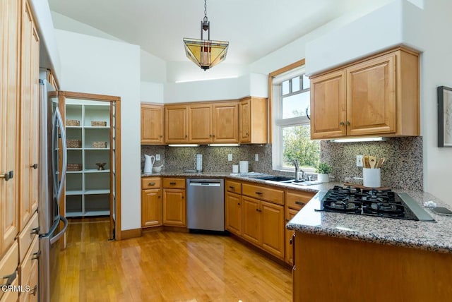 kitchen with stainless steel appliances, light wood-style flooring, tasteful backsplash, stone counters, and pendant lighting