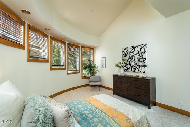 bedroom featuring light colored carpet, baseboards, and vaulted ceiling
