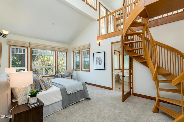 bedroom with high vaulted ceiling, carpet flooring, and baseboards
