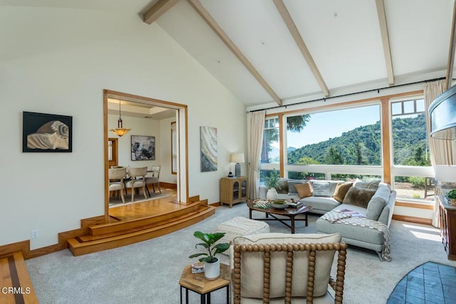 carpeted living room with high vaulted ceiling, beam ceiling, plenty of natural light, and baseboards