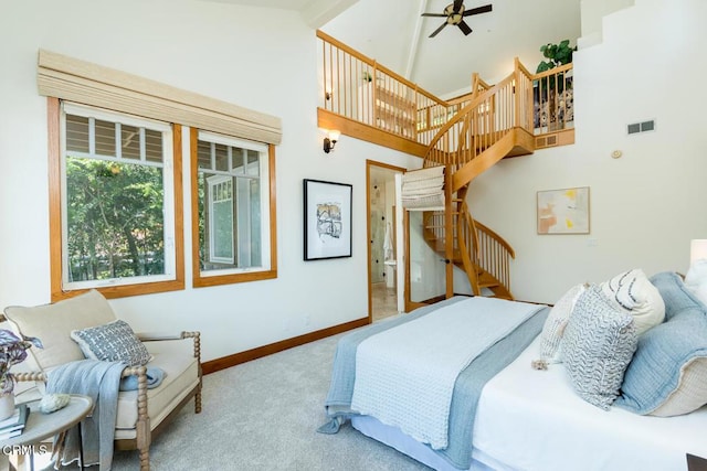 carpeted bedroom with baseboards and a high ceiling