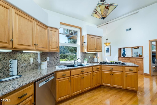 kitchen featuring stainless steel dishwasher, a sink, black gas stovetop, light wood-style floors, and decorative backsplash