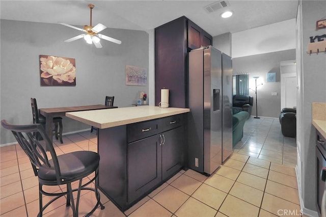 14696 Blackbush Rd, Moreno Valley, CA 92553 - kitchen with stainless steel fridge with ice dispenser, visible vents, light tile patterned floors, a peninsula, and ceiling fan