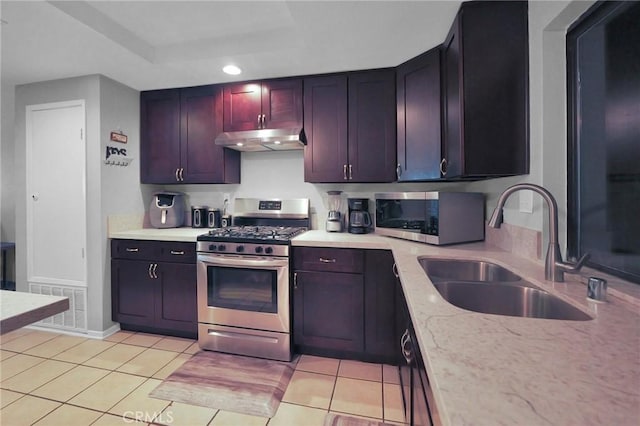14696 Blackbush Rd, Moreno Valley, CA 92553 - kitchen featuring under cabinet range hood, stainless steel appliances, visible vents, a sink, and light tile patterned flooring