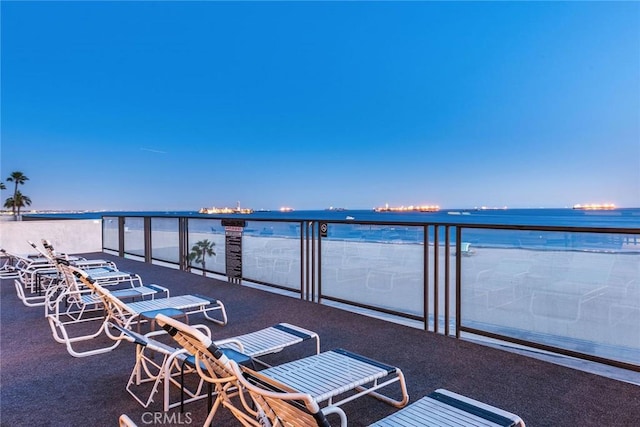 view of patio / terrace featuring a water view and a balcony