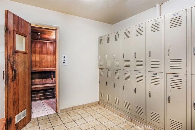 interior space featuring baseboards, light tile patterned flooring, and visible vents