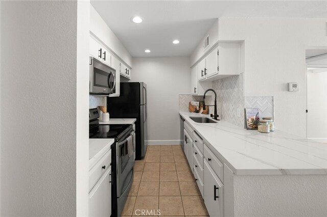 1140 E Ocean Blvd Unit 220, Long Beach, CA 90802 - kitchen featuring stainless steel appliances, a sink, decorative backsplash, white cabinets, and light tile patterned floors