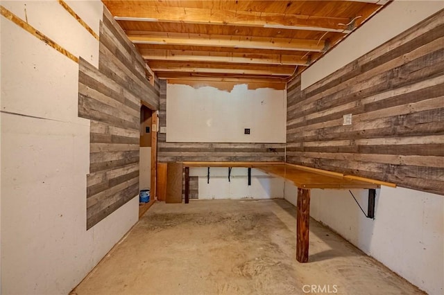 unfinished basement featuring wood walls
