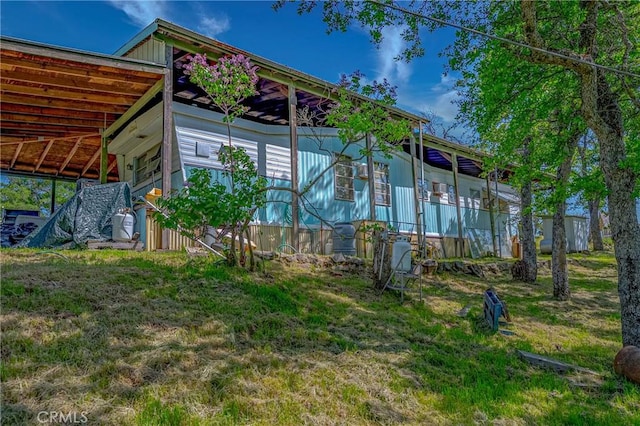 rear view of property with a lawn