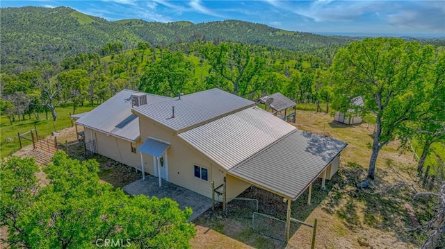 drone / aerial view with a mountain view and a view of trees