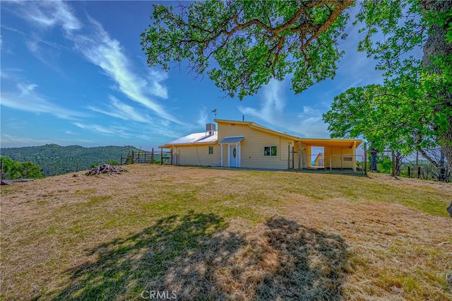 back of house with a yard and fence