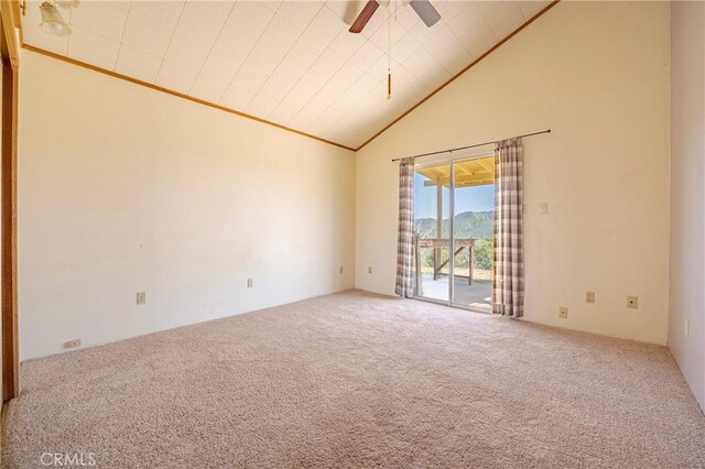 carpeted spare room featuring high vaulted ceiling and a ceiling fan