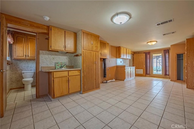 kitchen with light tile patterned floors, light countertops, and visible vents