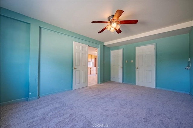 interior space featuring ceiling fan and baseboards