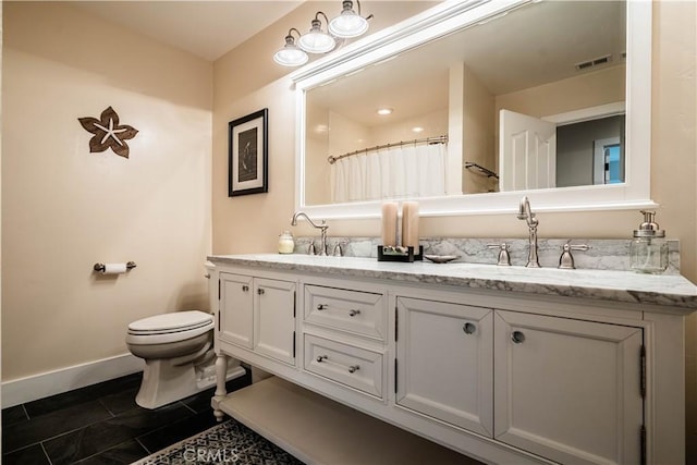 bathroom with visible vents, baseboards, a sink, and toilet