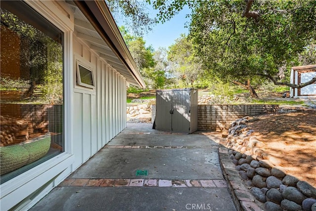 exterior space with board and batten siding and a patio