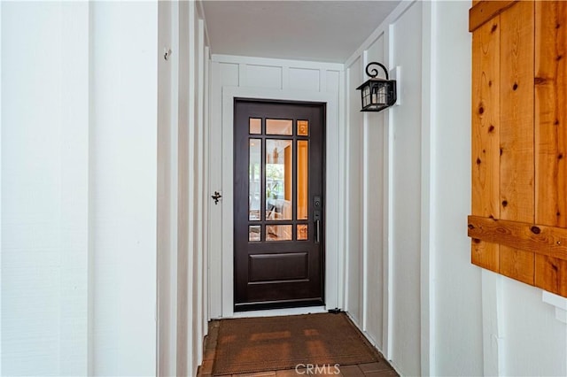 view of exterior entry featuring board and batten siding