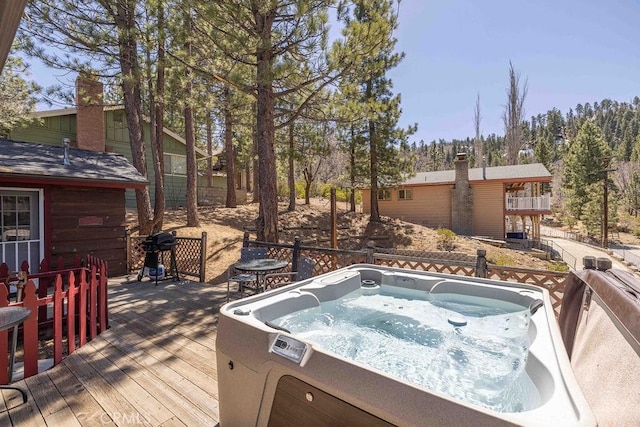 wooden terrace featuring a grill and a hot tub