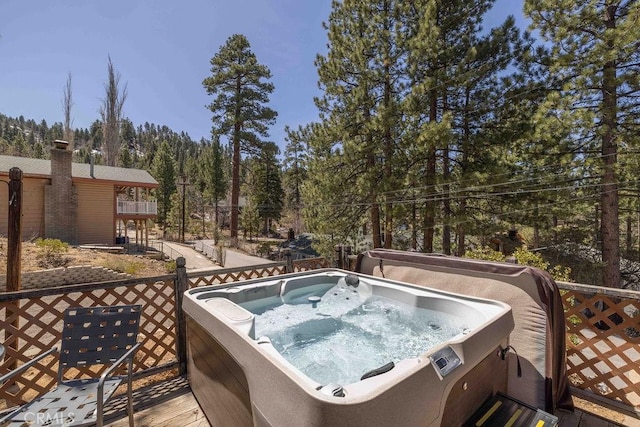 wooden deck featuring a hot tub