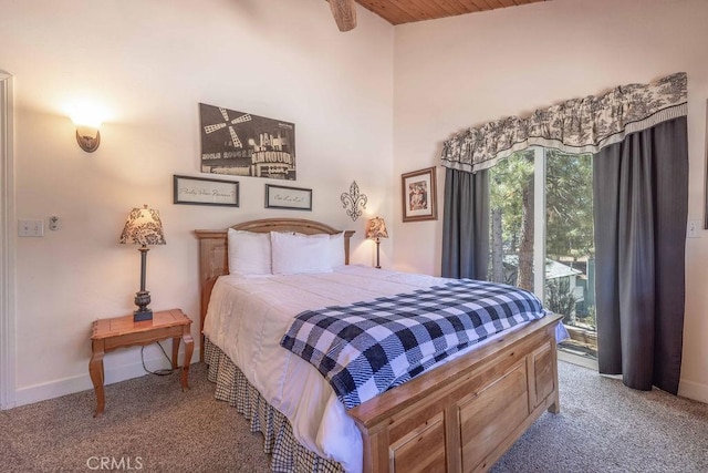 carpeted bedroom featuring access to exterior and baseboards