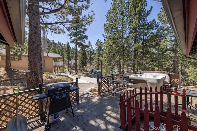 wooden deck featuring a grill