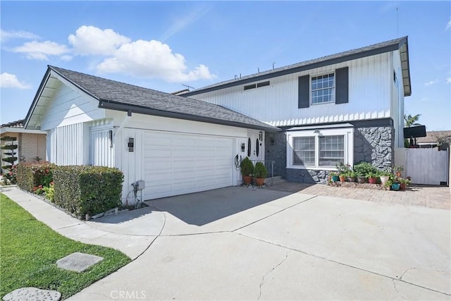 5201 Del Serra Cir, La Palma, CA 90623 - traditional-style house with stone siding, a garage, and concrete driveway