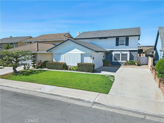 5201 Del Serra Cir, La Palma, CA 90623 - traditional-style house featuring driveway, an attached garage, and stone siding