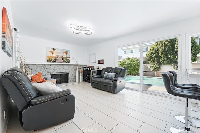 5201 Del Serra Cir, La Palma, CA 90623 - living room featuring healthy amount of natural light, a stone fireplace, and light tile patterned floors