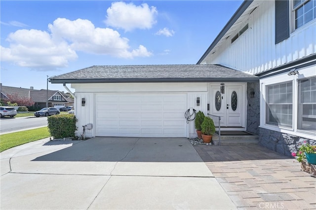 5201 Del Serra Cir, La Palma, CA 90623 - view of front facade with board and batten siding, driveway, and a garage