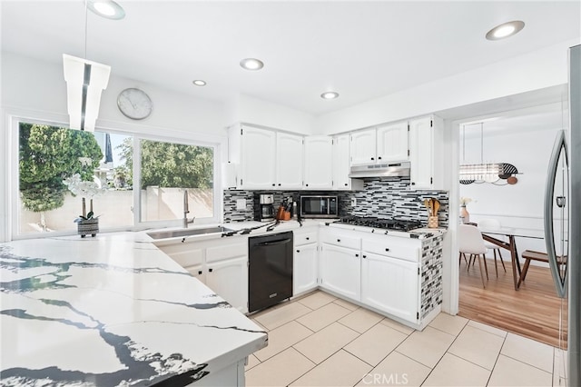 5201 Del Serra Cir, La Palma, CA 90623 - kitchen featuring appliances with stainless steel finishes, a sink, under cabinet range hood, light stone countertops, and backsplash