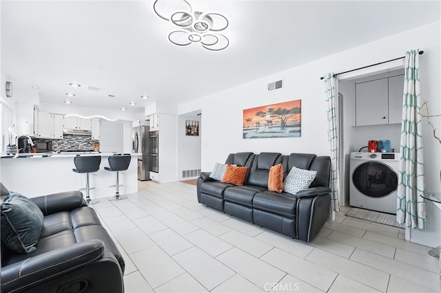 5201 Del Serra Cir, La Palma, CA 90623 - living area with washer / dryer, light tile patterned flooring, and recessed lighting