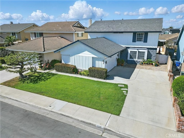5201 Del Serra Cir, La Palma, CA 90623 - view of front of home with driveway, a garage, stone siding, and a residential view