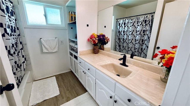 5201 Del Serra Cir, La Palma, CA 90623 - full bath featuring vanity, wood finished floors, baseboards, and shower / bath combo