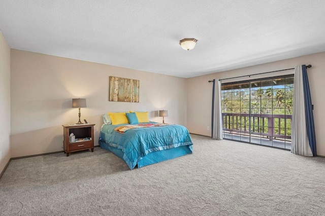 carpeted bedroom featuring a textured ceiling and access to exterior