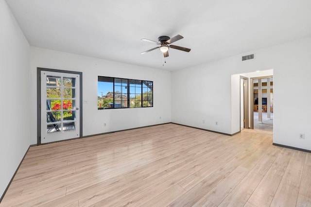 unfurnished room featuring ceiling fan, visible vents, baseboards, and light wood-type flooring